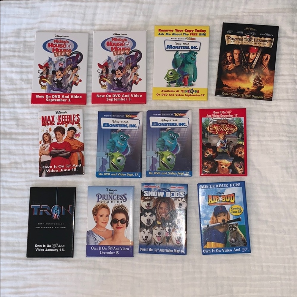 12 Disney and Disney Pixar promotional pins.